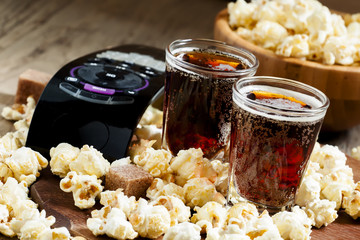 Popcorn, cola, tv remote, selective focus