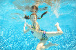 © Iuliia Sokolovska - Girl jumps and swims in pool underwater, happy active child has fun in water, kid sport