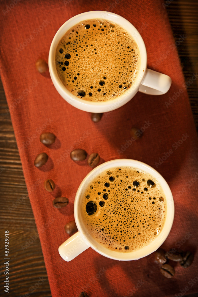 Cups of coffee on napkin on table close up