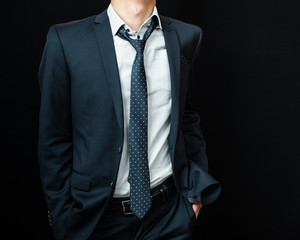 Wall Mural - man in suit on a black background