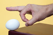 Hand about to flick an egg