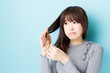 © taka - attractive asian woman hair care image on blue background