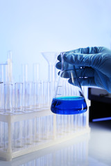 Wall Mural - test tube in scientist hand in laboratory