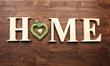 © Africa Studio - Decorative letters forming word HOME with heart on wooden background