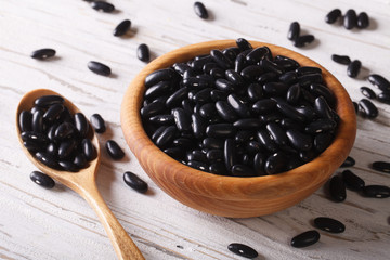 Poster - Raw black beans in a wooden spoon and a bowl horizontal
