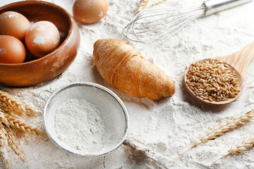 Canvas Print - Preparing croissant on white flour background