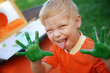 © natalinka29 - Boy with hands painted in green paints ready to make hand prints
