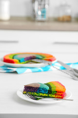 Wall Mural - Delicious rainbow cake on plate, on  light background