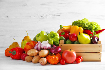 Wall Mural - Heap of fresh fruits and vegetables on wooden background