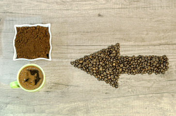  Arrow from the coffee beans with a cup of fresh ground coffee an