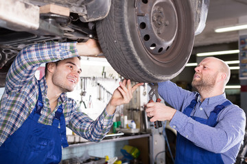 Two car mechanics at workshop