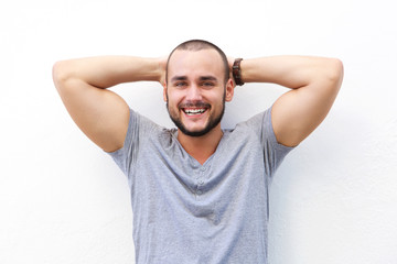 Wall Mural - Handsome young man smiling with hands behind head