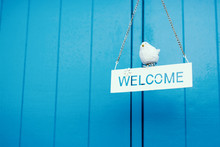 Welcome Sign On The Wooden Background