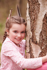 Wall Mural - Young Girl Hugging Tree In Forest