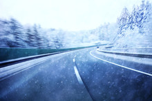 Dangerous Blurred Highway Winter Driving. Winter Snowy Conditions On The Highway. Motion Blur Visualizies The Speed And Dynamics.