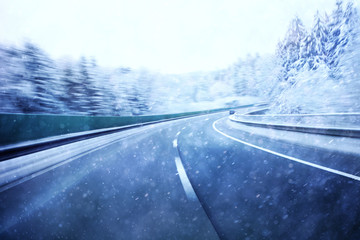 Dangerous blurred highway winter driving. Winter snowy conditions on the highway. Motion blur visualizies the speed and dynamics.