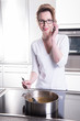 © Jürgen Hüls - attractive woman in modern ktchen cooking and on the phone