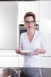 © Jürgen Hüls - attractive woman in modern ktchen cooking and eating soup