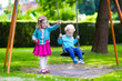 © famveldman - Kids on playground swing