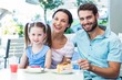 © WavebreakmediaMicro - Portrait of a family eating at the restaurant