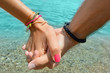 © creativefamily - Couple holding hands at sea