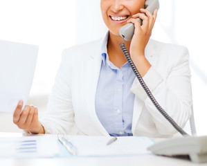 african businesswoman with phone in office