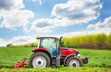 Aufkleber - Red tractor mows the grass.
