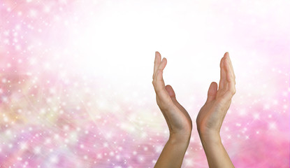 Wall Mural - Sending  Healing Energy - Female healing hands reaching up from a pink sparkling energy background 