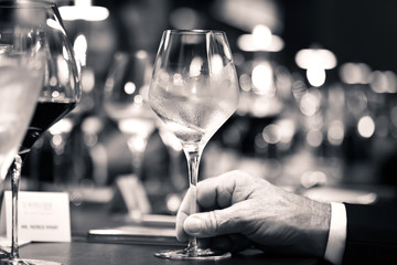 Wall Mural - black and white of white wine on hand with dinner on restaurant