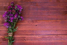 Burdock Flowers On A Wooden With Copy Space