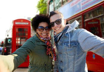 Sticker - happy teenage couple taking selfie in london city