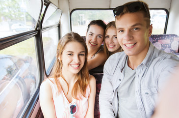 Wall Mural - happy teenage friends traveling by bus
