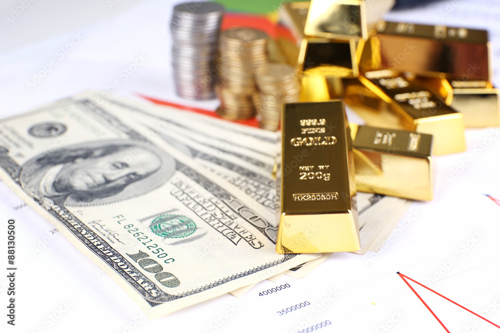 Gold bullion with money on table close up