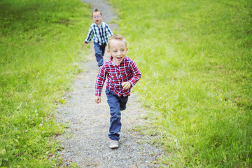 Portrait of two cute little boy child outdoors on the nature