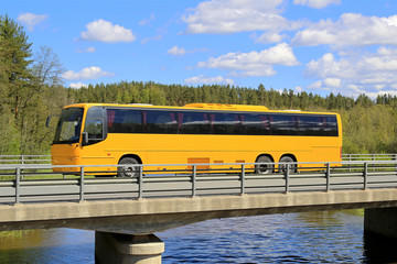 Wall Mural - yellow coach bus on scenic bridge