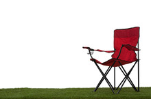 Folding Camp Chair On Grass With White Background