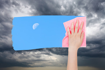 Poster - hand deletes storm clouds by pink cloth