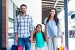 © WavebreakmediaMicro - Portrait of a happy family with shopping bags