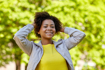 Canvas Print - happy african american young woman in summer park