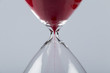 Red sand in an hourglass, horizontal