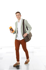 Wall Mural - Man holding handbag on light background