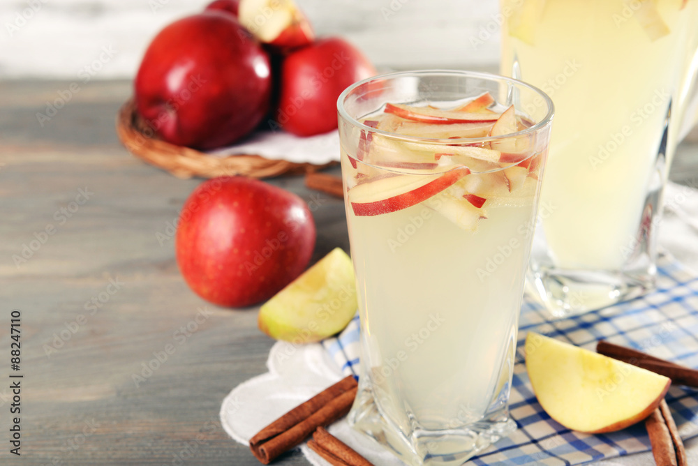 Glasses of apple cider with fruits on table close up