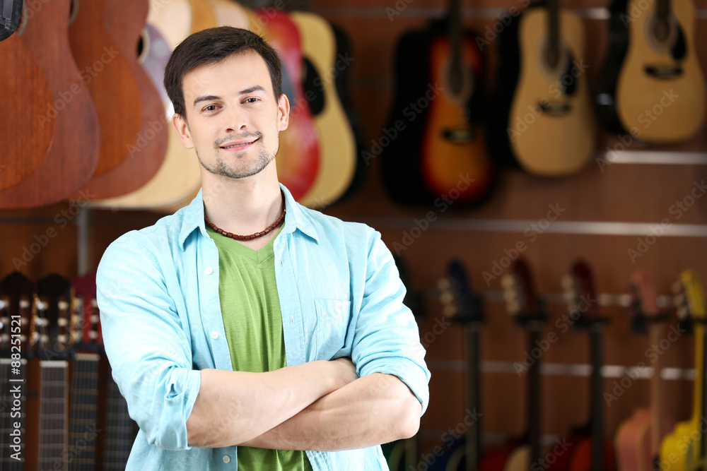 Handsome young man in music store