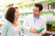 Attractive pharmacist advising a patient
