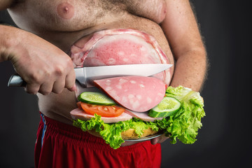 Man cutting sausage for sandwich