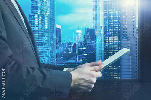 Close Up Of Side View Of A Businessman Who Is Browsing On His Tablet - 