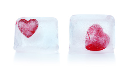 Red hearts in ice cubes isolated on white