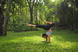 © chayathon2000 - Young woman doing yoga exercises in the garden park