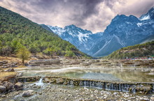 HDR Image Of Cascading Falls At Baishuihe, Or White Water River With Jade Dragon Snow Mountain, Lijiang, Yunnan, China