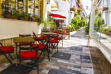 Fototapeta Uliczki - streets of Marbella restaurant tables, Spain